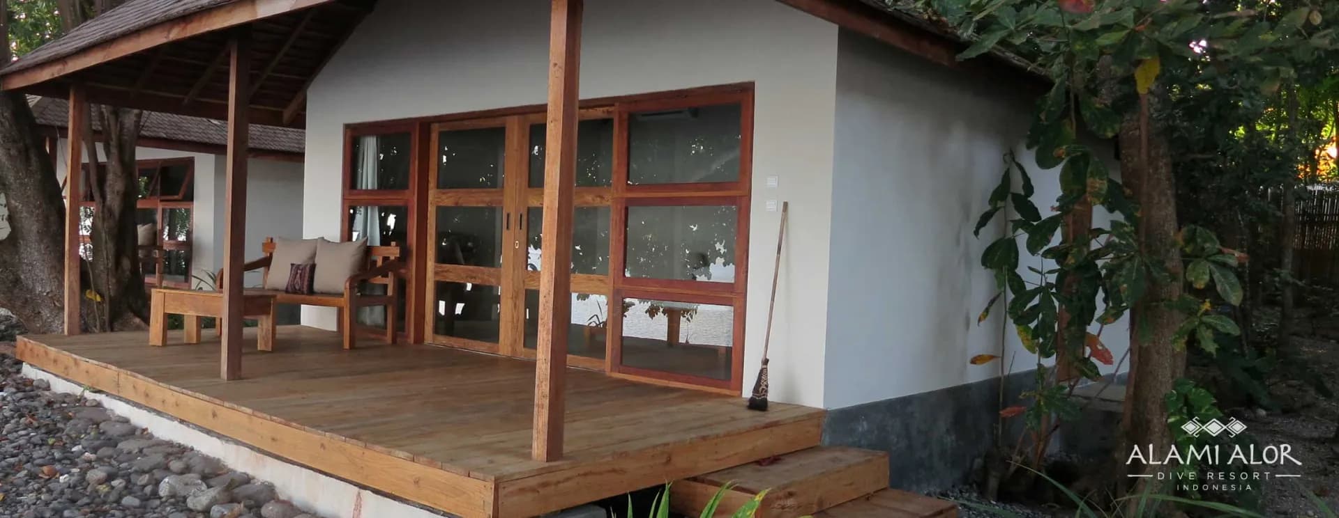 A bungalow with a tidy deck and chairs at Alami Alor resort. A bungalow with a tidy deck and chairs at Alami Alor resort.