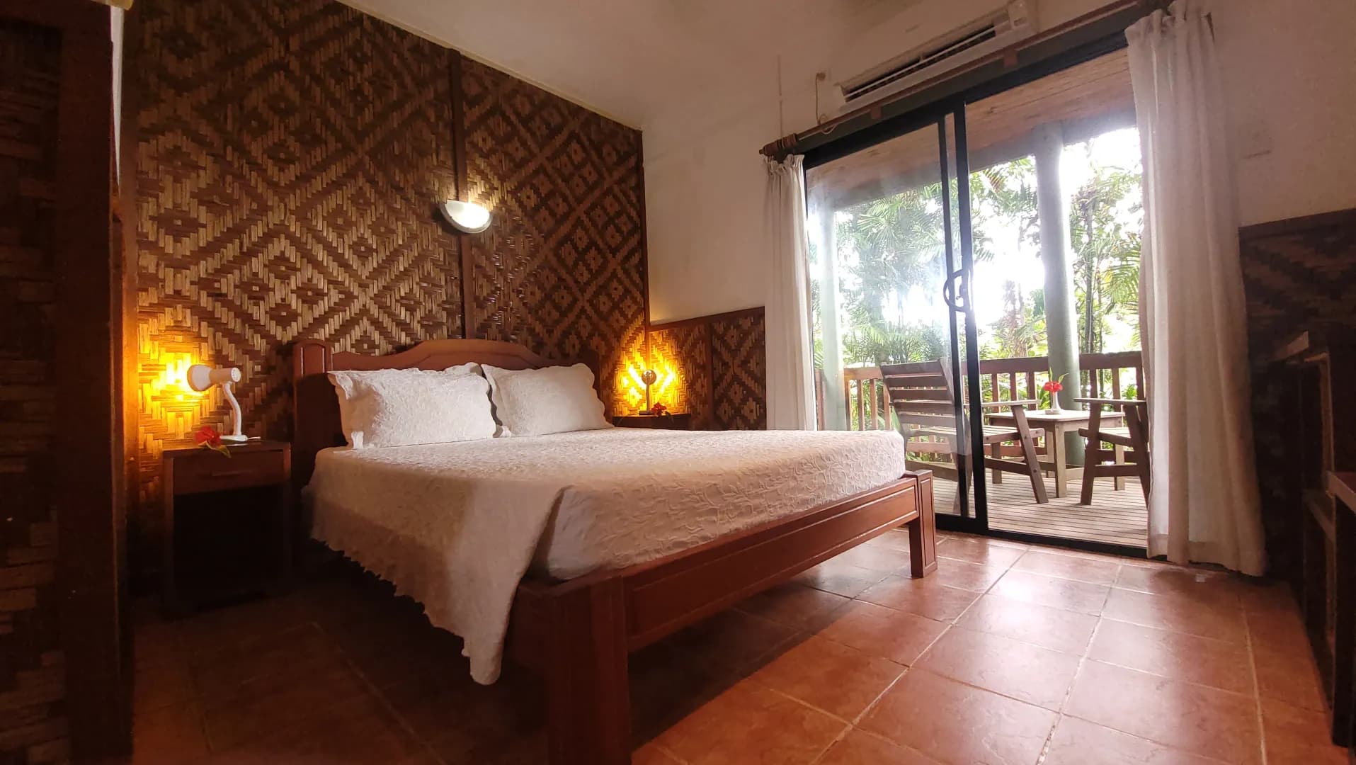 A bed in a deluxe room at Tufi Resort Papua New Guinea A bed in a deluxe room at Tufi Resort Papua New Guinea