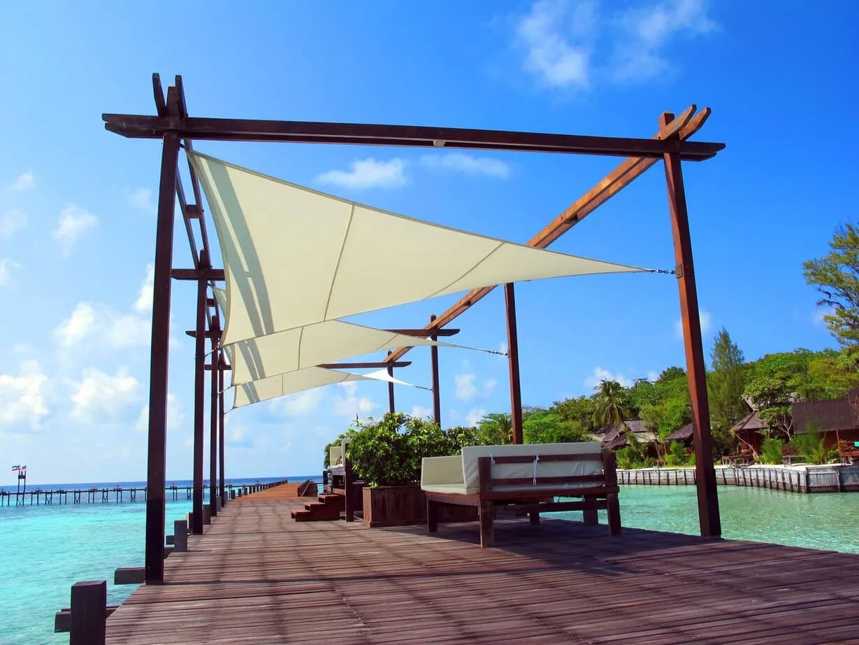 A seating area is shaded with sailcloth on a jetty at Lankayan Island Resort A seating area is shaded with sailcloth on a jetty at Lankayan Island Resort